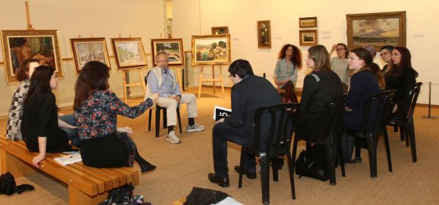 Claude Ghez speaks with students in the course about the paintings in his father's collection