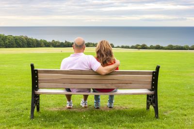Man with teenage child on a bench